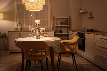 Human skeleton model with fork near dining table in kitchen at night