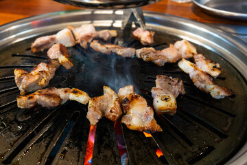 roasting pork on the charcoal grill