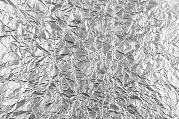 Metallic silver crumpled foil texture background, stylish and luxury design perfect for packaging, branding, and creative art projects.