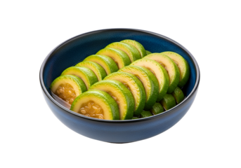 Sliced green fruit in a deep blue bowl against a black background.