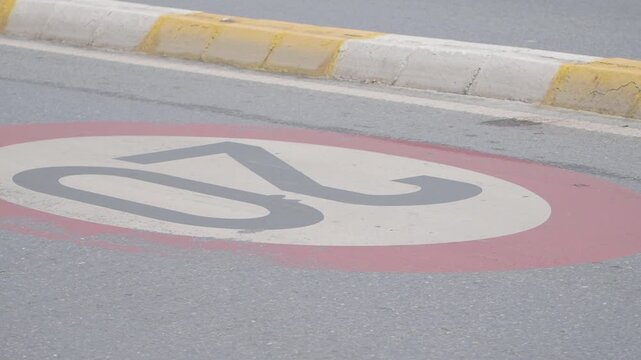 Speed limit sign marking on the road in a busy area