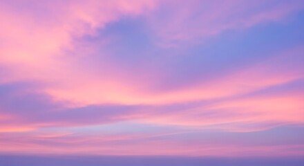 Obraz premium Soft, pastel pink and purple sunset sky with clouds.