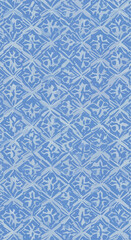 Intricate blue pattern with floral diamond shapes creating a textured design.