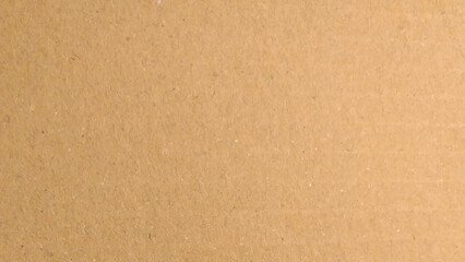 Background of brown kraft paper or cardboard texture. Abstract pattern of beige rough carton, old paper sheet.