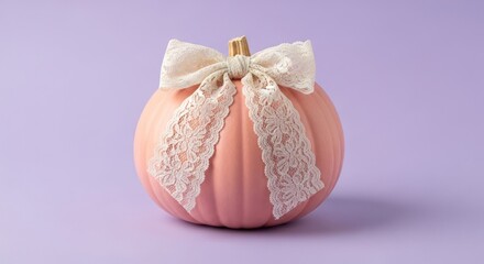 Elegant pink pumpkin adorned with a delicate lace bow on purple backdrop