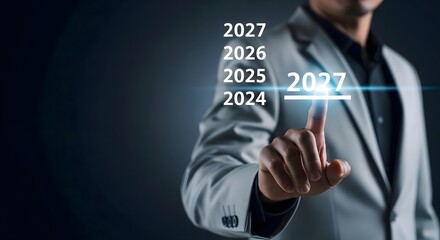 Obraz premium A man in a suit interacting with a digital interface displaying the year 2027 with other years above