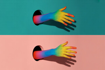 Fototapeta premium Rainbow hands emerging from colorful walls