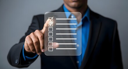 Businessman completing checklist on virtual screen using touch interface and mobile device app