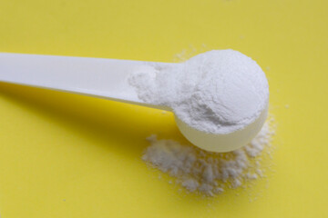 White creatine powder, used as a pre-workout supplement for gym and fitness.