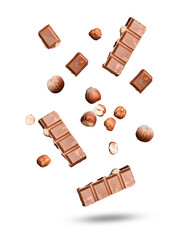 chocolate bars and hazelnuts scattered on a dark surface