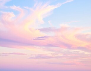 Fototapeta premium Dreamy clouds at sunrise. Sky is pastel pink, violet and light blue, swirled in feathery patterns, evoking a feeling of serenity