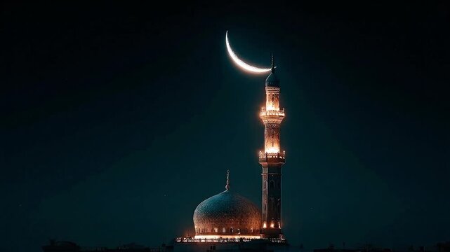Lit mosque with crescent moon at night showcasing its ornate tower  dome against a dark sky