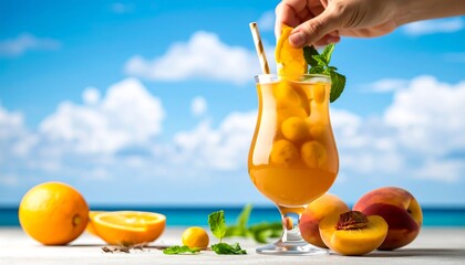 A hand garnishes a large iced cocktail with orange slice and mint,  surrounded by peaches, oranges, and a beach scene