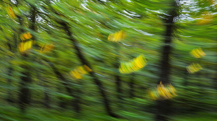 Windy Day in Lush Forest with Tree Leaves Fluttering in Breeze, Creating Dynamic Motion Against a Blurred Green Background
