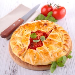 Baked tomato tart on a wooden board