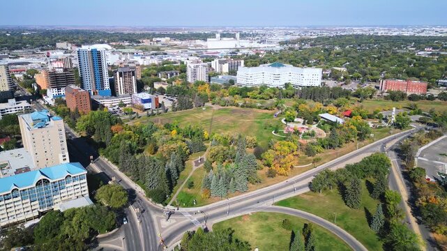 Autumn aerial reveals colorful trees, clear horizon, city stretching beyond