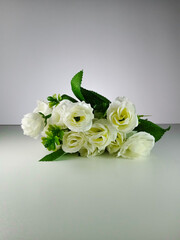 Picture of artificial white rose with white background. This photo can be used for wedding organizer advertising or other advertising that related to marriage