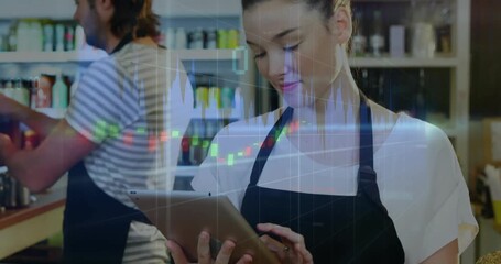 Barista lifting tablet over basket and scrolling financial chart overlay as coworker making coffee - Powered by Adobe