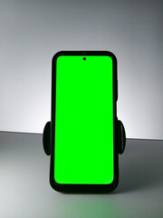 Picture of a smartphone showing green screen. This photo can be used for advertising 