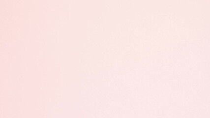 Yellow crumpled paper unfolds then refolds on pink in stop motion transition