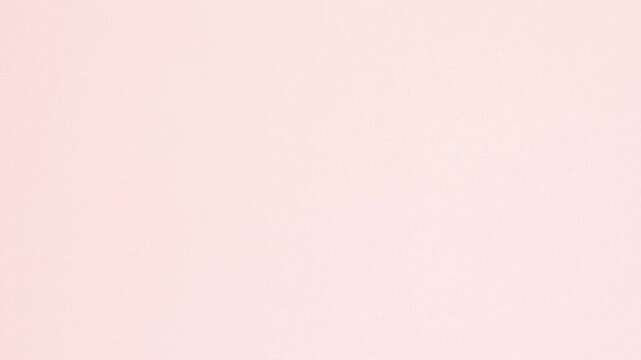 Yellow crumpled paper unfolds then refolds on pink in stop motion transition