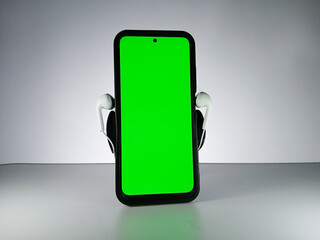 Picture of a smartphone showing green screen with earphones attached. This photo is taken with white background. This photo can be used for musical theme advertisement or music related promotion