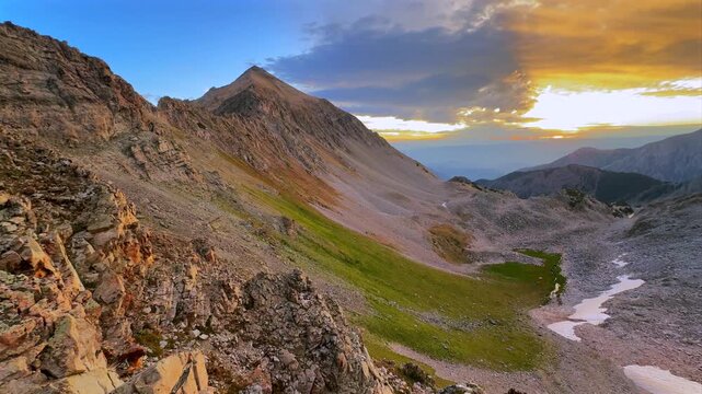 Aspen Snowmass Wilderness vibrant sunrise Capitol Peak Trailhead Ridge route Mt Daly K2 Colorado Rocky Mountain Elk Range scenic nature landscape high alpine elevation sun ray clouds pan right motion