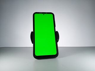 Picture of a smartphone showing green screen. This photo can be used for advertising 