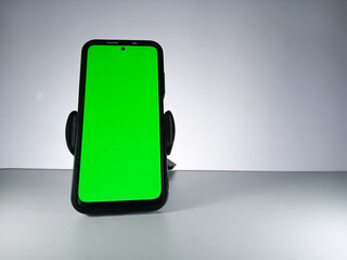 Picture of a smartphone showing green screen. This photo can be used for advertising 