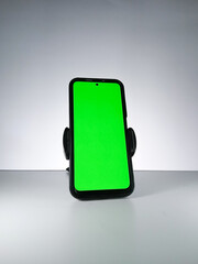 Picture of a smartphone showing green screen. This photo can be used for advertising 