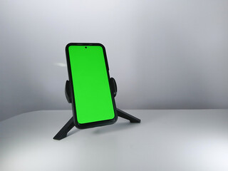 Picture of a smartphone showing green screen. This photo can be used for advertising 