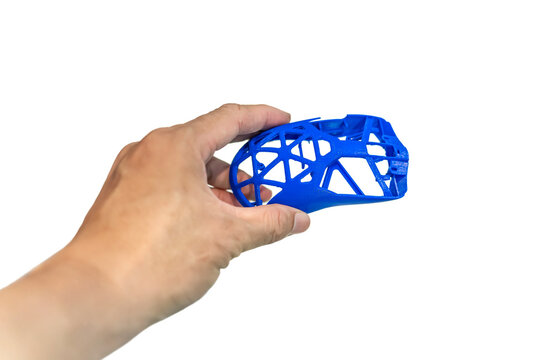 hand with hollow computer mouse object printed on 3d printer close-up