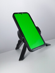 Picture of a smartphone showing green screen. This photo can be used for advertising 