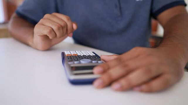 Person Calculating and Writing Notes, Person using a calculator and writing on paper