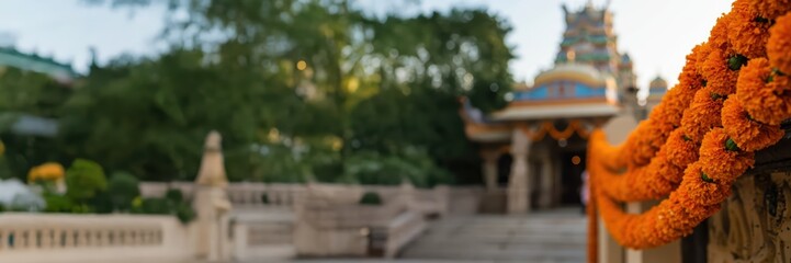 Orange marigold flower garland frames a traditional Indian temple against an empty background. Indian festive decorations for Hindu celebrations, for banners or posters, with copy space.	
