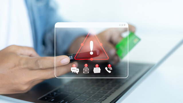 Businessman holding a credit card with a fraud alert warning, online scam, phishing attack, cybercrime, and financial security risk awareness for internet safety and data protection.