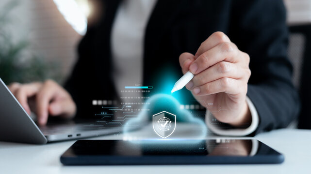 Businessman using tablet with digital cloud security icon, data protection, cybersecurity, online safety and cloud computing technology for secure business and digital transformation.