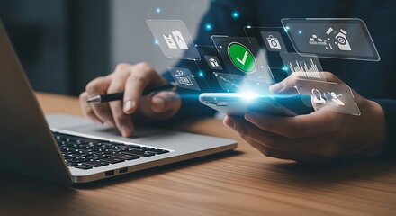Close up of a person using a smartphone and laptop with futuristic digital interface and glowing icons overlayed on the screen representing technology and connectivity