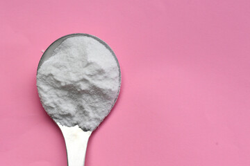 White creatine powder, used as a pre-workout supplement for gym and fitness.
