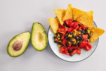 healthy nachos with corn black beans tomato avocado and corn chips