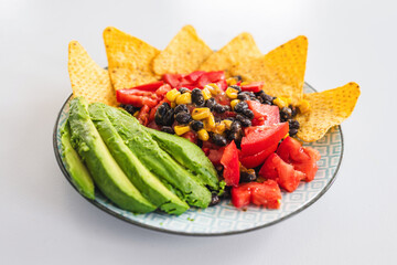 healthy nachos with corn black beans tomato avocado and corn chips
