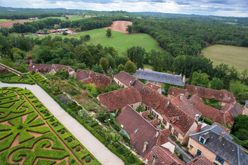 French formal garden at Hautefort Castle, with the village in the background, in Dordogne, France
