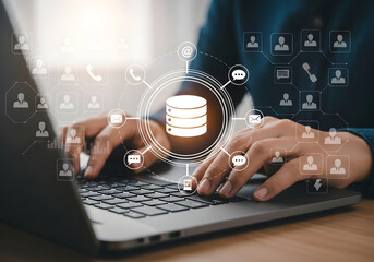 Hands typing on a laptop with a glowing database icon and network of people icons symbolizing data management and connectivity