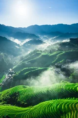 Selbstklebende Fototapeten Reisfelder Aerial view of beautiful green terraced rice fields and traditional village in morning mist. spectacular Longji terraced fields natural landscape in Guilin, Guangxi Province, China.  © ABCDstock