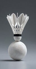 White shuttlecock balanced on a sphere