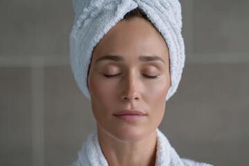 A woman is wearing a white towel and looking at the camera