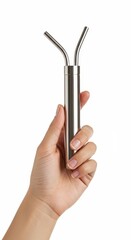 A hand holds a metallic drinking bottle with double straws, showcasing a simple yet stylish accessory.