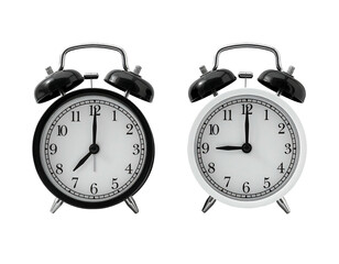 Two vintage-style alarm clocks, one black and one white, showing a similar time