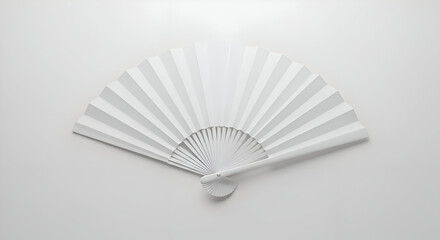 White paper fan displayed flat on a plain surface. Elegant, simple design with folds and handle.