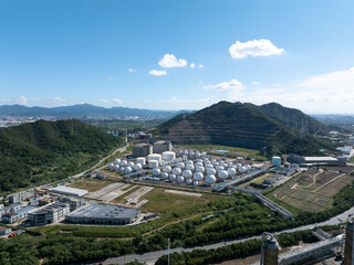 Aerial views of industrial areas with numerous large storage tanks